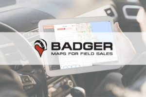 picture of a person holding a tablet and usingf Badger Mapping, a route sales software