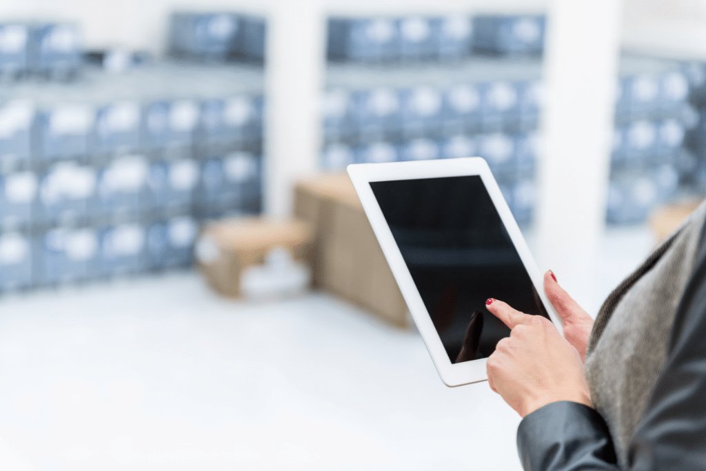 warehouse worker using tablet with Inventory Replenishment Software